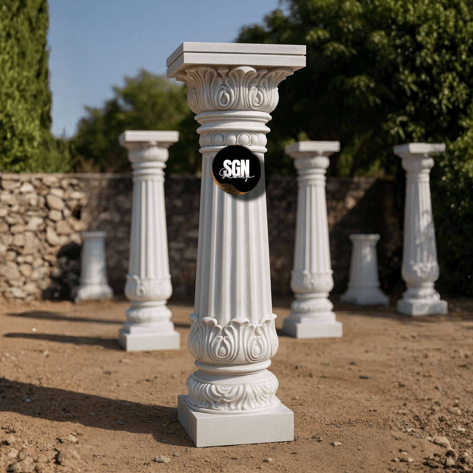 A set of carved white marble pillars arranged in an outdoor space for construction and design projects.