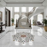 Spacious luxury villa entrance featuring a polished white Makrana marble floor with a large, intricate floral inlay medallion in red, green, and gold stones, set in front of a curved grand staircase. | Luxury Marble Inlay Flooring